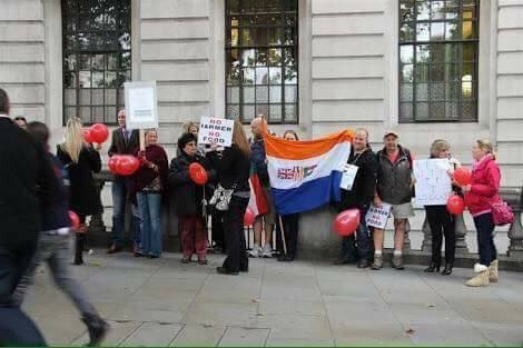 Image is for illustration purposes only and shows the old SA flag being displayed at a protest in front of SA House, London, UK in October 2013.