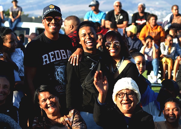 A family amongst the crowd enjoying the CTFDA Freestyle Dance Revolution Youth Day Event in Macassar